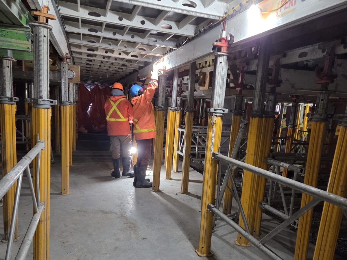 Keep Clean crew working among shoring posts inside a building under construction