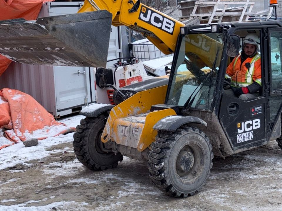 A Keep Clean operator driving a telehandler on a winter site